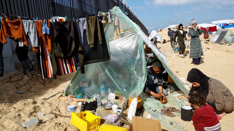 Families shelter at the Gaza border with Egypt in Rafah, south of the strip on 10 February. Pic: Reuters