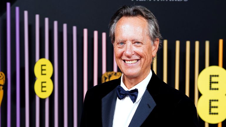 Saltburn star Richard E. Grant wearing a smart tuxedo - but joking he might whip it off for Sophie Ellis-Bextor&#39;s musical number . Pic: PA