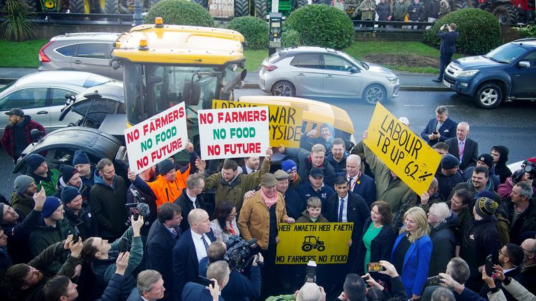 Rishi Sunak speaking with farmers after he delivered a speech at the Welsh Conservatives Conference 2024.
Pic: PA