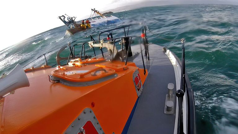 Four people being rescued after their fishing vessel sank off the west coast of Scotland
Pic:RNLI Oban HelmetCam/PA