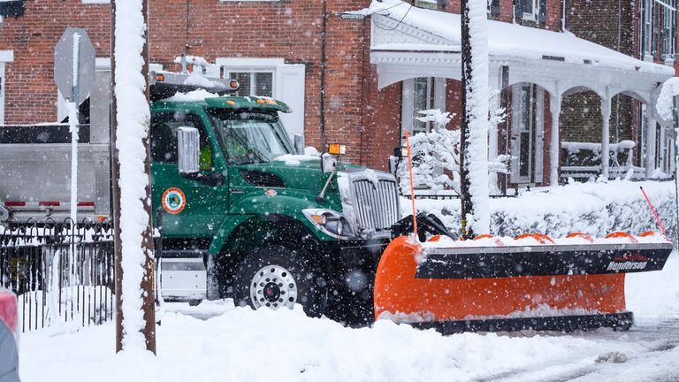 A plow works to clear snow during a winter storm in Doylestown, Pa., Tuesday, Feb. 13, 2024. (AP Photo/Matt Rourke)
