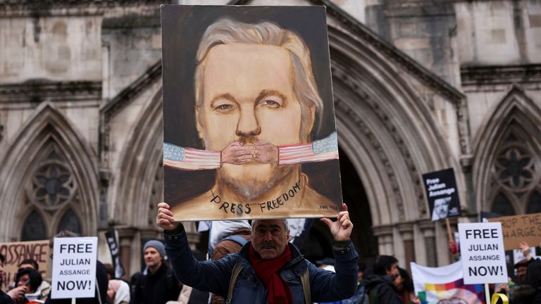 A supporter of WikiLeaks founder Julian Assange stands outside the high court on the day Assange appeals against his extradition to the United States.
Pic: Reuters