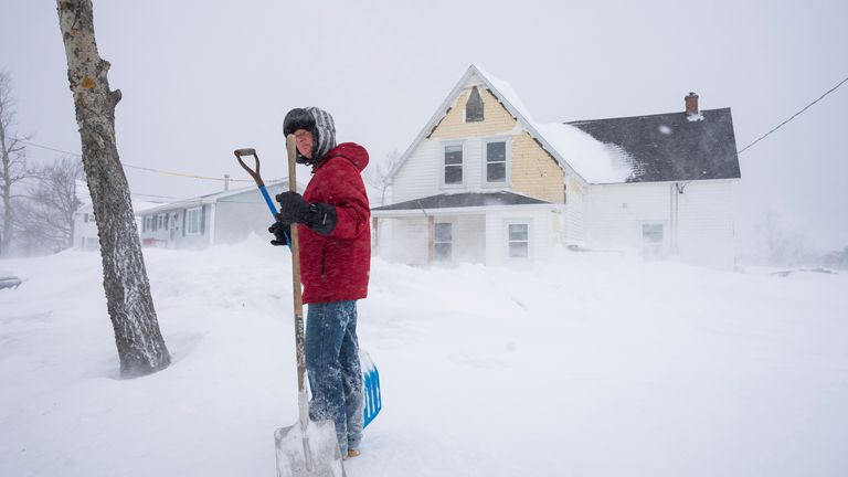 Corrine Penney gets set to shovel snow early in Sydney.
Pic: The Canadian Press /AP