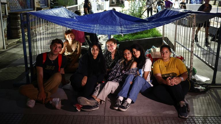 Taylor Swift fans pose for a photo inside their makeshift tent while lining up with others, some of them camping out for up to five months taking turns, to get a good spot at Swift&#39;s show, outside the Estadio Mas Monumental, in Buenos Aires, Argentina November 8, 2023. REUTERS/Tomas Cuesta