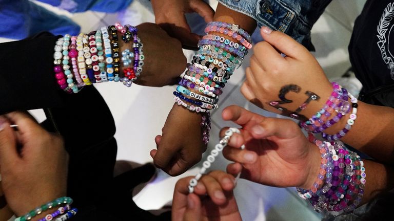Teenagers trade bracelets while waiting for the beginning of Taylor Swift&#39;s Eras Tour concert movie in a cinema in Mexico City, Mexico October 13, 2023. REUTERS/Alexandre Meneghini
