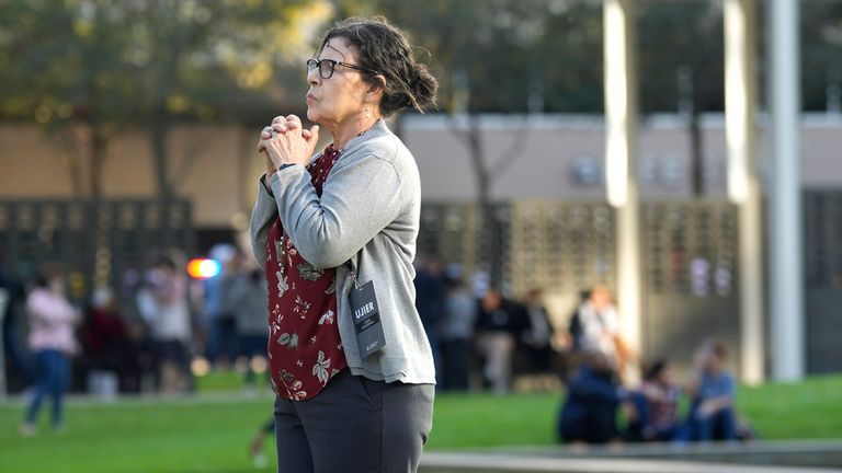 A woman stands outside Lakewood Church in Houston after a reported shooting during a Spanish church service, Sunday, Feb. 11, 2024. (Karen Warren/Houston Chronicle via AP)