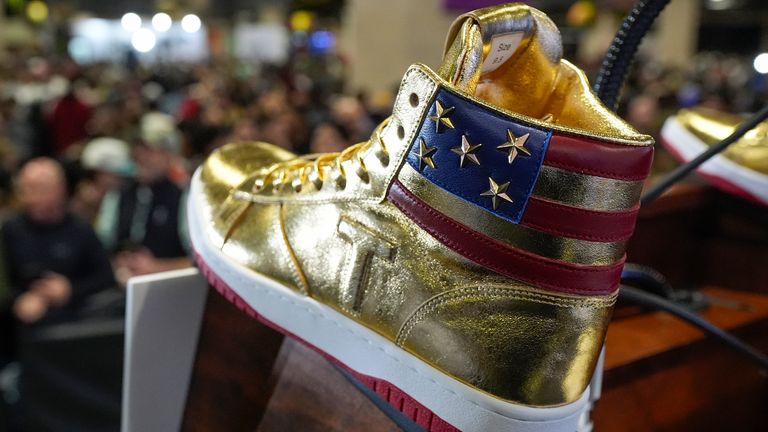 Gold Trump sneakers sit on the podium after Republican presidential candidate former President Donald Trump spoke at Sneaker Con Philadelphia, an event popular among sneaker collectors, and announces a gold Trump sneaker, in Philadelphia, Saturday, Feb. 17, 2024. (AP Photo/Manuel Balce Ceneta)