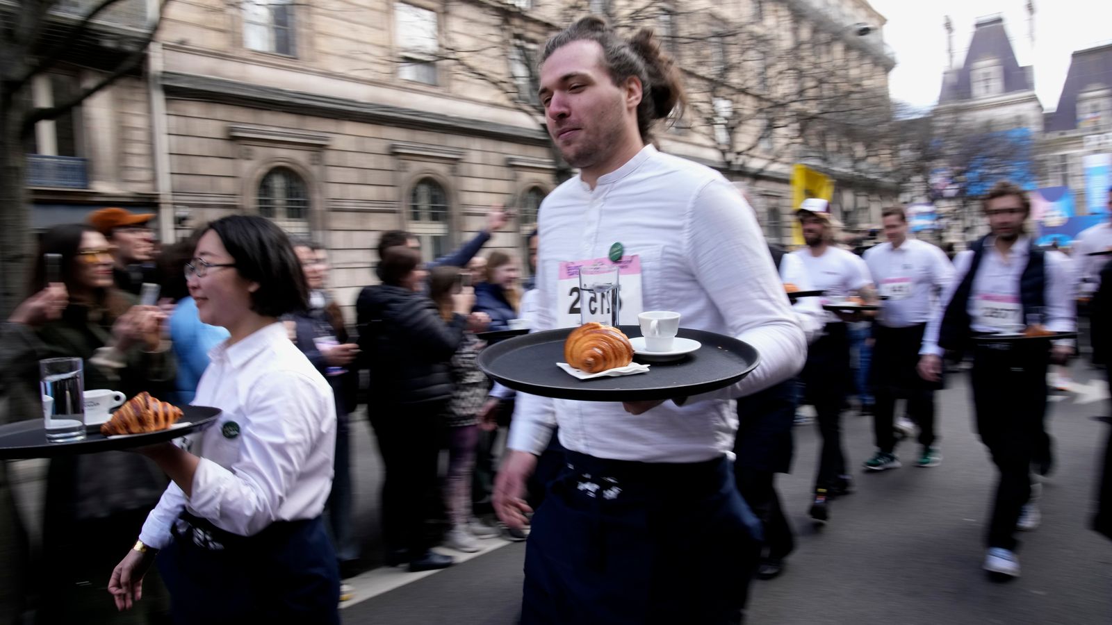 Waiters and waitresses race through streets of Paris for first time in ...