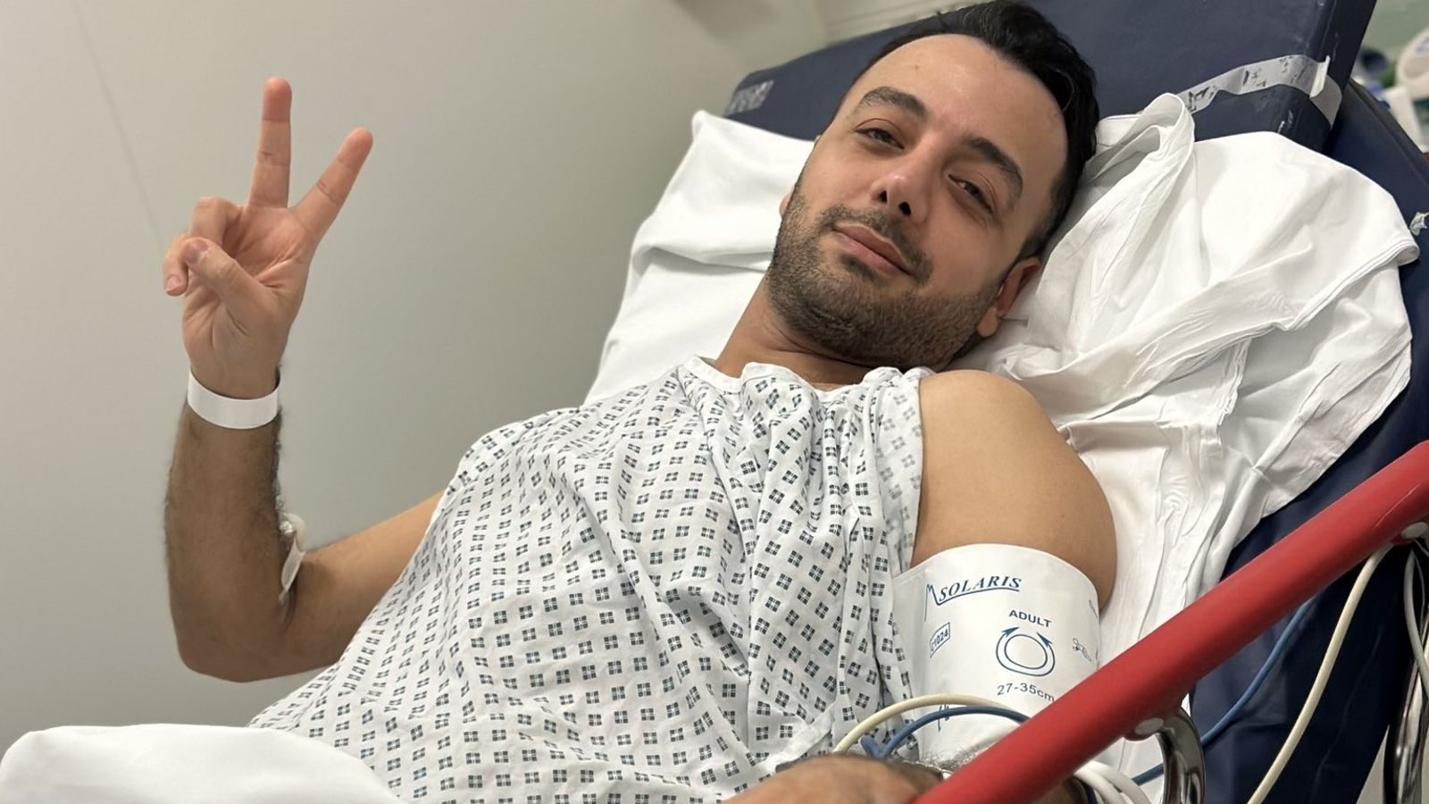 Pouria Zeraati: Iranian journalist shares defiant photo of himself from hospital bed after being stabbed in London | UK News
