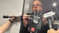 NASCAR managing director Brad Moran shows reporters the glove on Saturday. Pic: AP