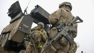 Danish soldiers stand beside vehicles as Dynamic Front military exercise led by the United States takes place in a training area, in Oksbol, Denmark March 30, 2023. REUTERS/Fabian Bimmer
