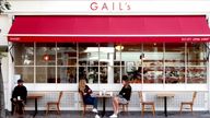 Customers observe social distancing as they sit outside a branch of Gail&#39;s bakery on Upper Street in Islington, North London.