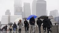 People walk in the rain over London Bridge.
Pic: PA