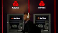 A man walks past ATM machines at branch of the NatWest bank in Manchester, Britain September 21, 2017. Picture taken September 21, 2017. REUTERS/Phil Noble