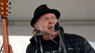 Rock legend Neil Young performs during a rally against the destruction of old-growth forests on the front lawn of the legislature in Victoria, British Columbia, on Saturday, Feb. 25, 2023. (Chad Hipolito/The Canadian Press via AP)