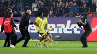 A Trabzonspor supporter, right, confronts Fenerbahce&#39;s players during clashes at the end of the Turkish Super Lig match. Pic: AP
(Huseyin Yavuz/Dia Images via AP)