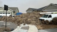 Tumbleweed piles up in front of houses in Eagle Mountain, Utah.
Pic:.Britta Jarvie/Reuters