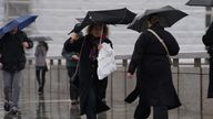 People walk in the rain over London Bridge in central London. Picture date: Tuesday March 12, 2024. PA

