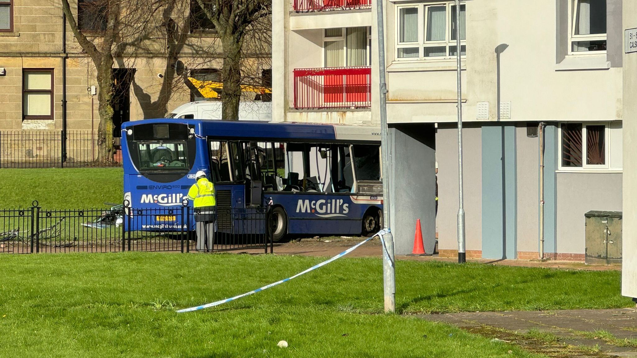 Five people taken to hospital after bus crashes into block of flats in ...