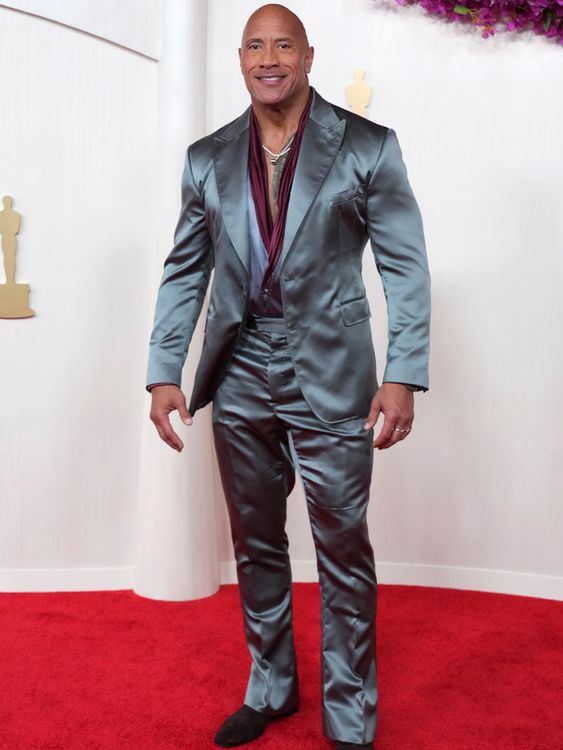 Charcoal gray for Dwayne Johnson, and his trademark broad smile lighting up the red carpet. Pic: AP