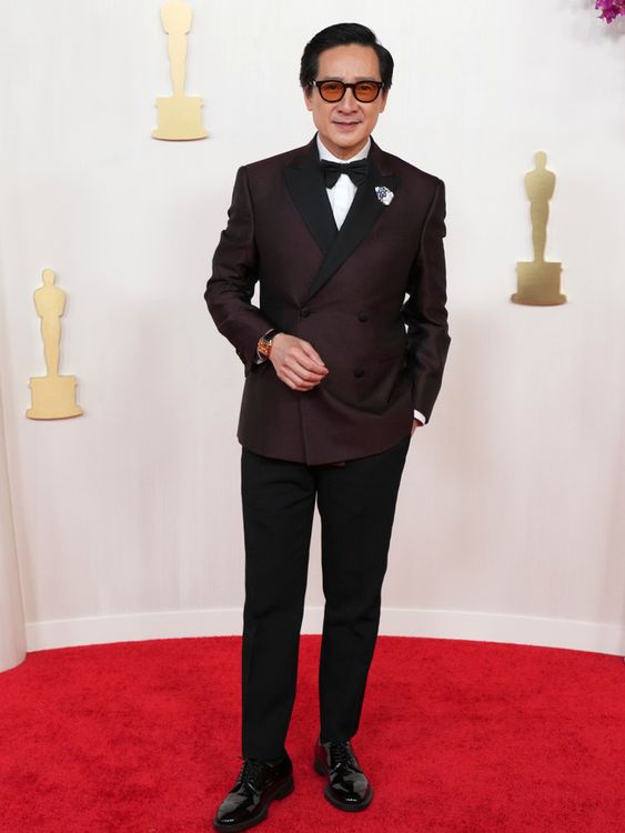 Everything Everywhere star Ke Huy Quan bucks the black and white trend in a burgundy suit, Pic: AP