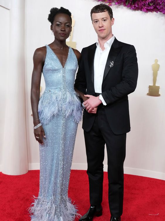Lupita Nyong&#39;o in sequins and feathers with Stranger Things star Joseph Quinn on her arm. Pic: AP