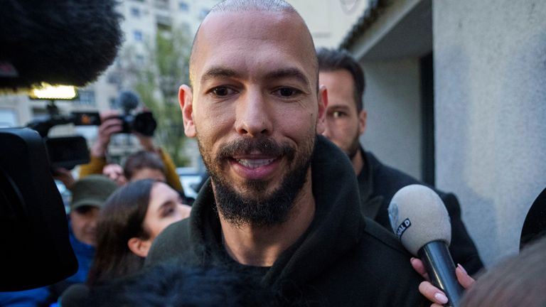 Andrew Tate leaves a police detention facility.
Pic:AP