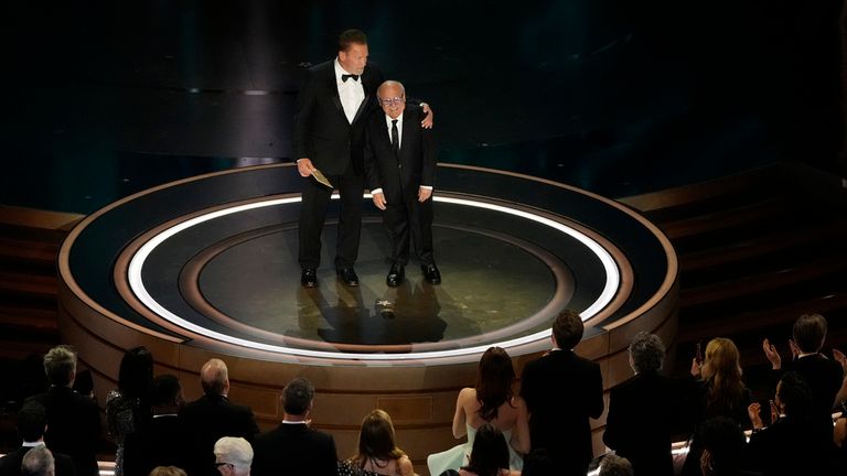 Arnold Schwarzenegger, left, and Danny DeVito presents the award for best visual effects during the Oscars on Sunday, March 10, 2024, at the Dolby Theatre in Los Angeles. (AP Photo/Chris Pizzello)