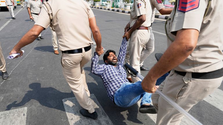 A supporter of Aam Admi Party, or Common Man&#39;s Party, is detained by the police officials during a protest against the arrest of their party leader Arvind Kejriwal.
Pic: AP