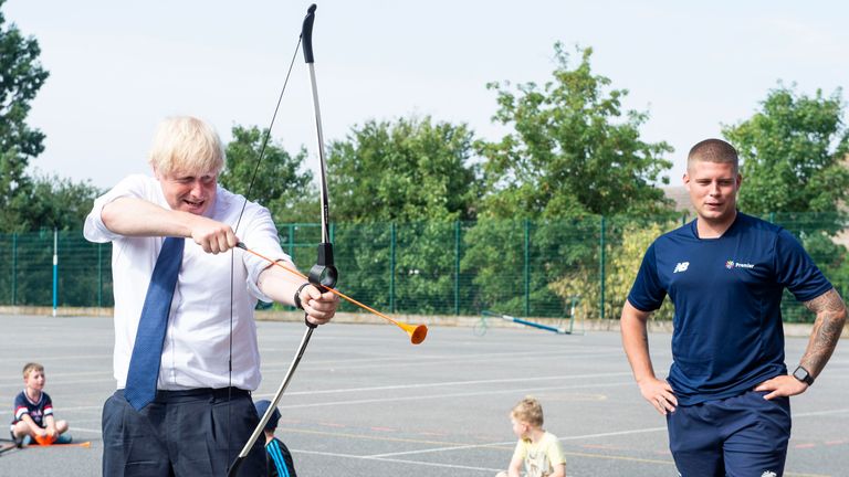Britain&#39;s Prime Minister Boris Johnson takes part in archery during visit to a summer camp in 2020. Pic: AP