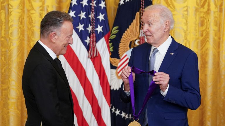 U.S. President Joe Biden presents singer Bruce Springsteen with a National Medal of Arts medal during a ceremony in the East Room at the White House in Washington, U.S., March 21, 2023. REUTERS/Kevin Lamarque
