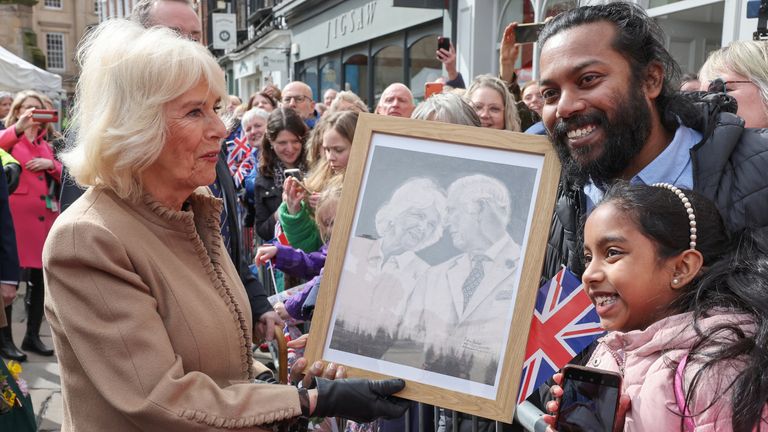 Queen Camilla receives artwork of herself and King Charles from well-wishers during her visit to the Farmers&#39; Market, in Shrewsbury.
Pic: Reuters