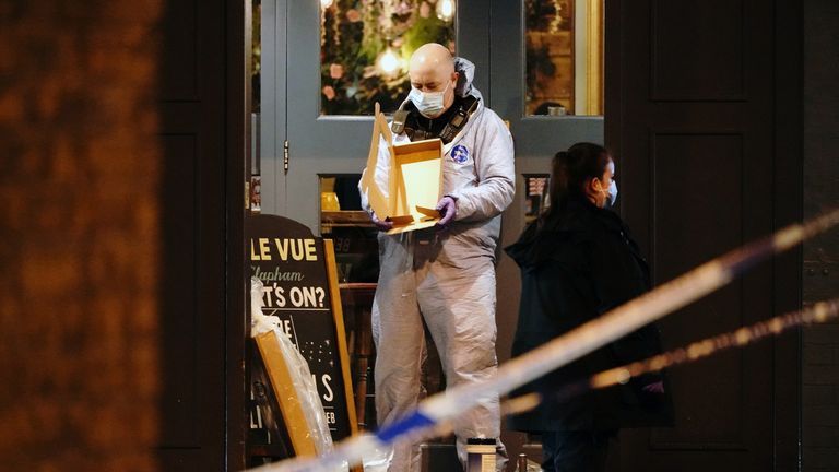 A forensic officer at the scene of a shooting in Clapham, London. Three people have been hurt after shots were fired by a moped rider who was being pursued by police in south London. Picture date: Friday March 1, 2024.