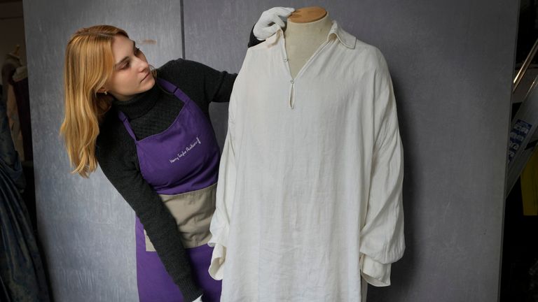 A costume handler arranges the famous shirt ahead of the auction Pic: AP 