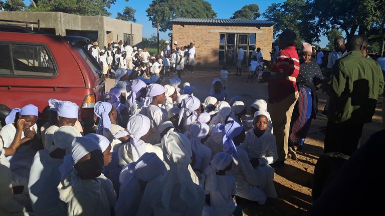 Children are rounded up at a shrine on the farm. Pic: AP