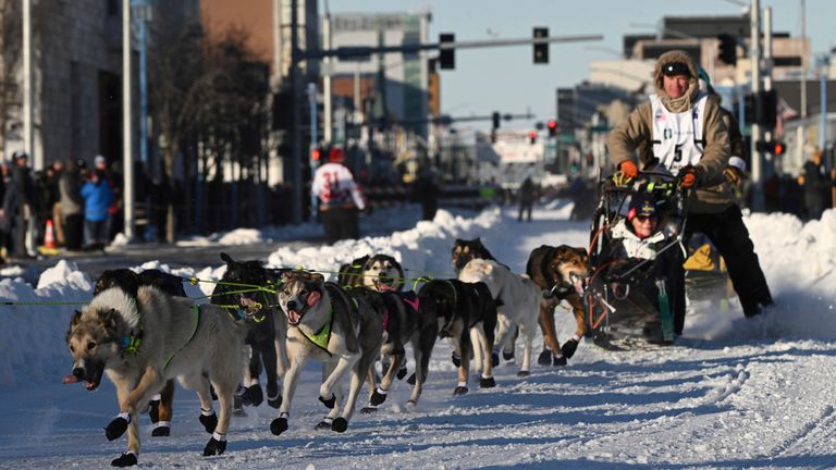 Mats Pettersson, from Sweden, makes the corner onto Cordova Street during the Iditarod Trail Sled Dog Race ceremonial start in Anchorage, Alaska, on Saturday, March 2, 2024. (Bob Hallinen/Anchorage Daily News via AP)