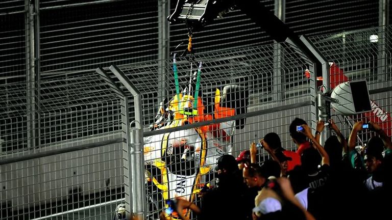 Nelson Piquet Jr&#39;s car is lifted by crane after he was ordered to crash. Pic: AP