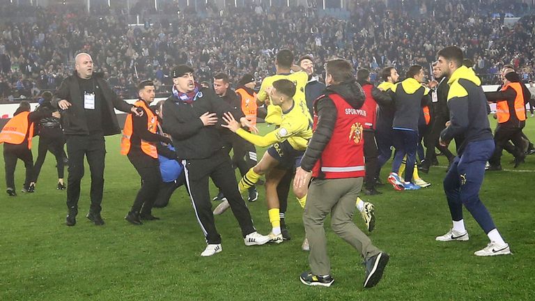 Fenerbahce&#39;s players clash with Trabzonspor supporters at the end of Turkish Super Lig soccer match between Trabzonspor and Fenerbahce. Pic: AP  (Huseyin Yavuz/Dia Images via AP)