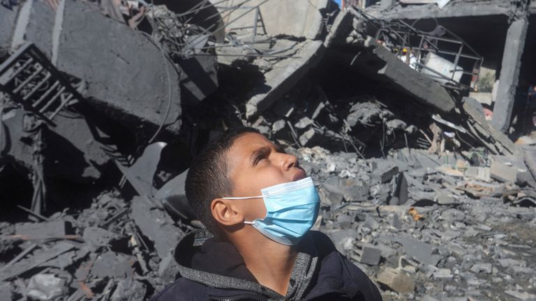 A young Palestinian boy at the site of an Israeli strike on a residential building. Pic: Reuters