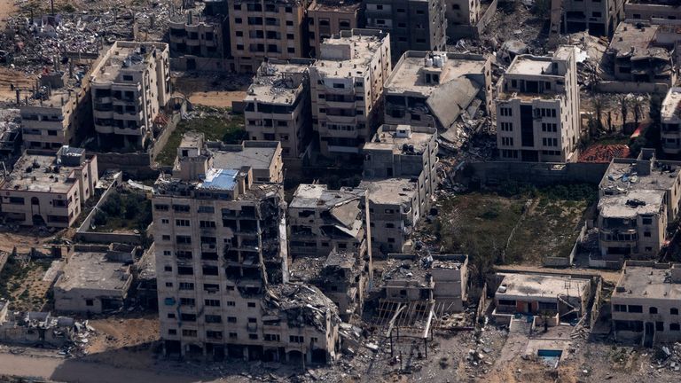 Destroyed buildings are seen through the window of an airplane from the U.S. Air Force, as they stand in the Gaza Strip, Thursday, March 14, 2024. (AP Photo/Leo Correa)