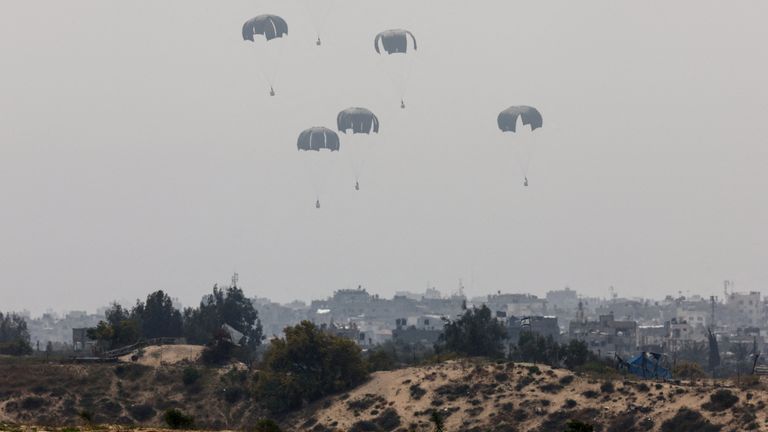 Humanitarian aid falls through the sky towards the Gaza Strip, as seen from Israel. Pic: Reuters