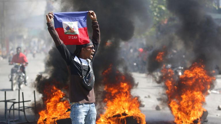 A demonstrator holds up an Haitian flag during protests demanding the resignation of Prime Minister Ariel Henry earlier this month. Pic: AP