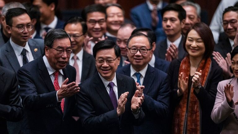 Hong Kong's Chief Executive John Lee Ka-chiu applauds with lawmakers following the passing of Article 23. Pic: AP