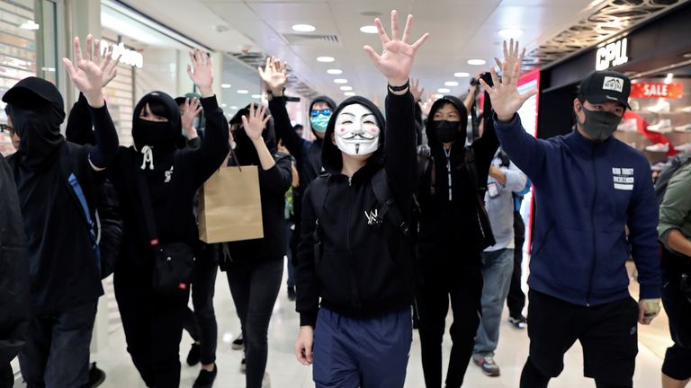 Anti-government demonstrators raise their hands during a protest in Sheung Shui shopping mall, Hong Kong, in December 2019. Pic: Reuters/Lucy Nicholson
