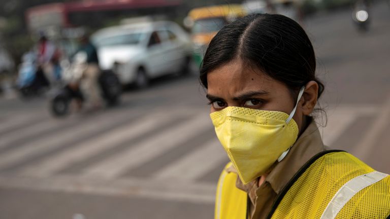 A policewoman wears a mask to protect herself from air pollution. Pic: Reuters