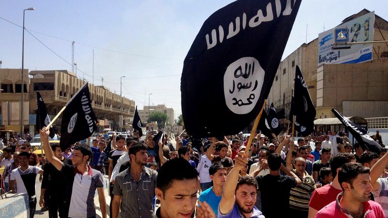 FILE - In this June 16, 2014 file photo, demonstrators chant pro-Islamic State group, slogans as they carry the group&#39;s flags in front of the provincial government headquarters in Mosul, 225 miles (360 kilometers) northwest of Baghdad, Iraq. (AP Photo, File)

