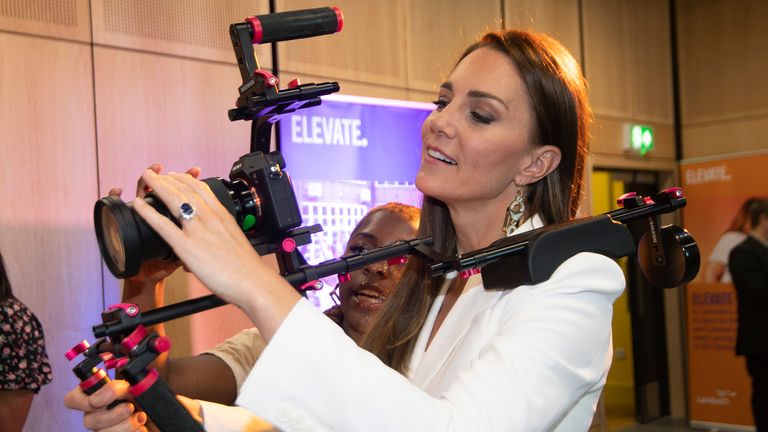 Britain's Kate, Duchess of Cambridge, holds a camera, druing a visit to ELEVATE, at Brixton House, in London, Wednesday, June 22, 2022. Prince William and Kate, Duchess of Cambridge met with younger generations of the British-Caribbean community, and other diasporas, who represent the next generation of British creative talent, to mark Windrush Day. (Eddie Mulholland/Pool Photo via AP)