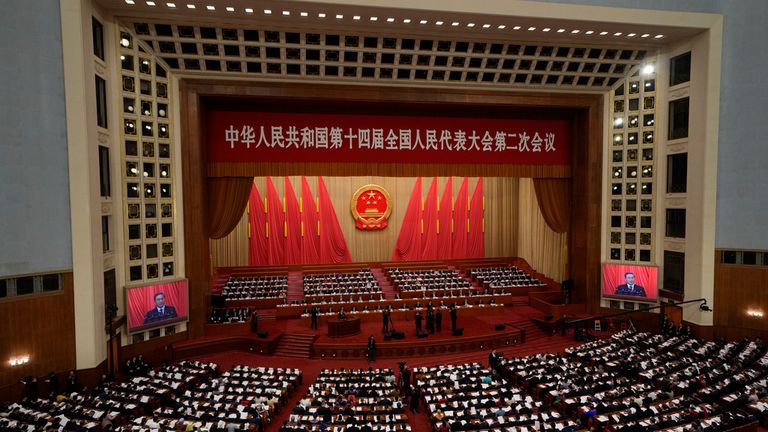 Chinese Premier Li Qiang, seen on screen, delivers his remarks in the Great Hall of the People. Pic: AP