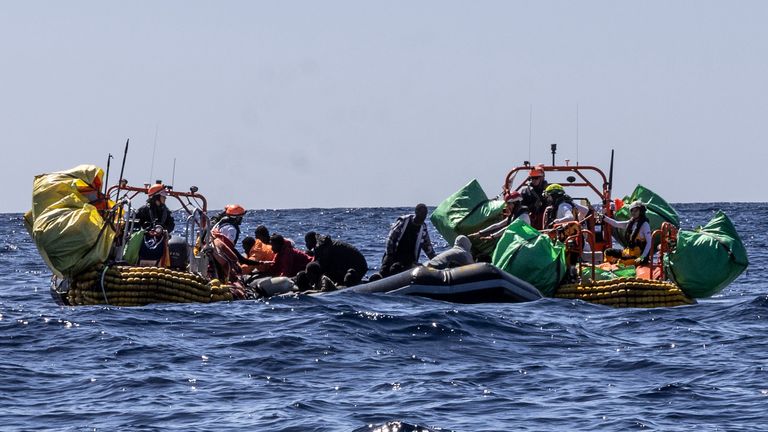 Migrants are helped evacuate a partially deflated rubber dinghy by the rescue personnel of the SOS Mediterranee humanitarian ship Ocean Viking in the Central Mediterranean Sea, Wednesday, March 13, 2024. Pic: Johanna de Tessieres/ SOS Mediterranee via AP, HO