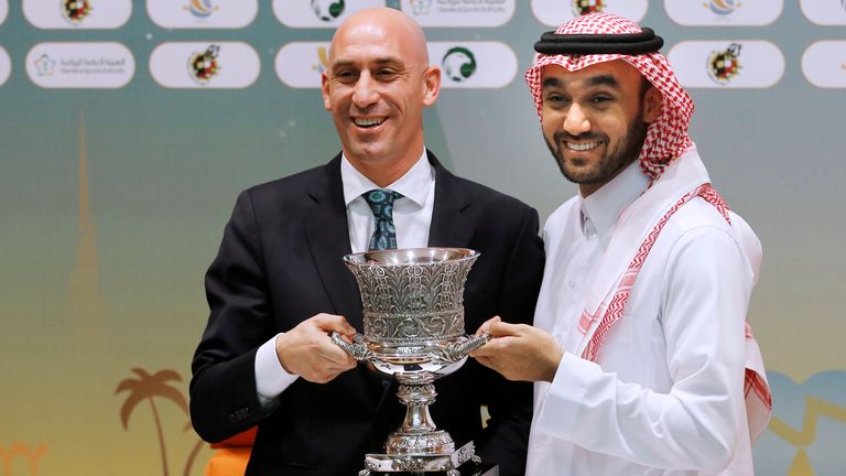 FILE - President of the Spanish Federation, Luis Rubiales, left, and Saudi General Sport Authority GSA chairman Prince Abdulaziz bin Turki Al-Faisal carry the Spanish super cup during a press conference in Jiddah Saudi Arabia, Wednesday, Dec. 18, 2019. (AP Photo/Amr Nabil, File)